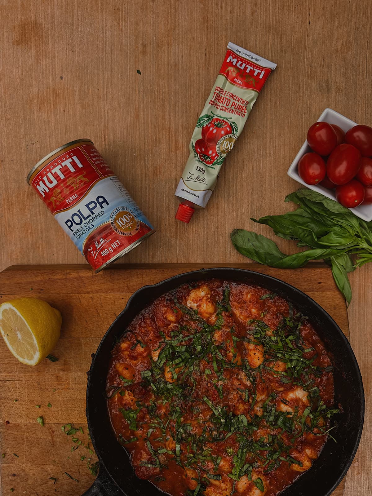 Shakshuka and Mutti passata on a wooden table